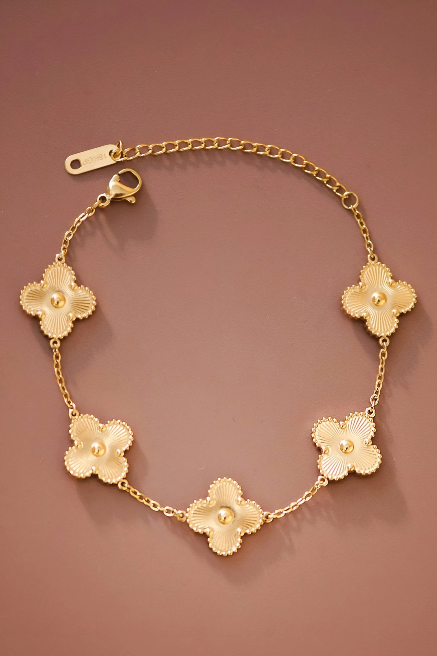 <!-- Product on white background -->
<img src="your-image-url-1.jpg" alt="18K gold plated clover bracelet with five charm links, designer inspired jewelry" />

<!-- Close-up of clover charms -->
<img src="your-image-url-2.jpg" alt="Close-up of 18K gold clover bracelet showing detailed charm design" />

<!-- Model wearing the bracelet -->
<img src="your-image-url-3.jpg" alt="Model wearing gold clover bracelet, minimalist luxury inspired jewelry"